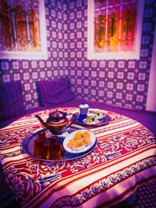 una mesa con un plato de comida en una mesa en Dar EL Hamra Maison Typique, en Mahdia