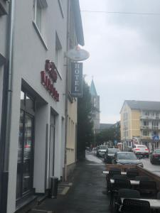 a building with a sign on the side of a street at Hotel Teatro in Kassel
