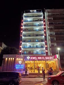 a tall building with a sign in front of it at Jewel Inn El Bakry Hotel in Cairo