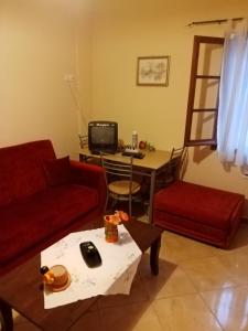 a living room with a couch and a table at Dolphins DreamHouse in Agios Ioannis Pelio