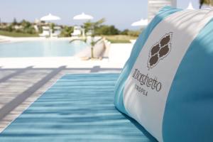 a blue and white inflatable slide next to a swimming pool at Il Borghetto Creative Resort in Tropea