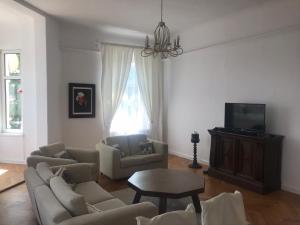 a living room with a couch and a table at Nokturn Apartament in Duszniki Zdrój