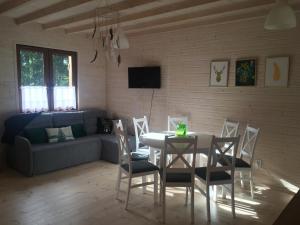 a living room with a table and chairs and a couch at LEŚNE RANCZO AGROTURYSTYKA in Międzychód