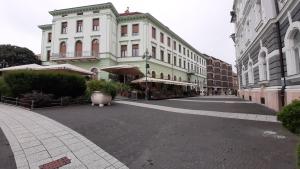 an empty street in a city with buildings at MHC Stúdió in Kaposvár