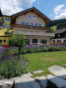 a large building with flowers in front of it at Appartements Frauenschuh in Schladming