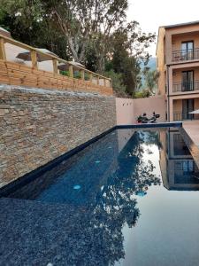 a swimming pool in front of a building at Hôtel Casa Mea in Bastia