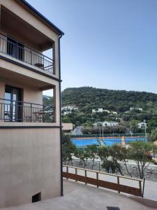 a building with a view of a swimming pool at Hôtel Casa Mea in Bastia