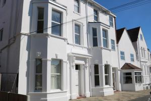 a white house with white doors and windows at Lennard House in Folkestone