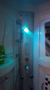 a bathroom with a shower with a blue light at "Athos"apartment potkrovlje in Višegrad +35 photos