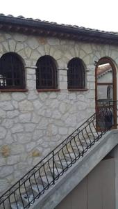 a stone building with three windows and a balcony at Le rêve bleu in Cagnes-sur-Mer