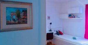 a room with a picture on the wall and a desk at Trogir family space 90m2 in Trogir +10 photos