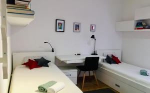 a bedroom with two beds and a desk and a chair at Trogir family space 90m2 in Trogir