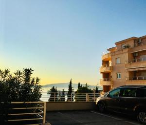 a car parked in a parking lot next to a building at Trogir family space 90m2 in Trogir