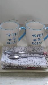 a table with two cups and utensils on a table at Le rêve bleu in Cagnes-sur-Mer