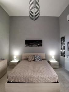 a bedroom with a large bed with two night stands at B&b Ci Vediamo Da Mario in Caserta