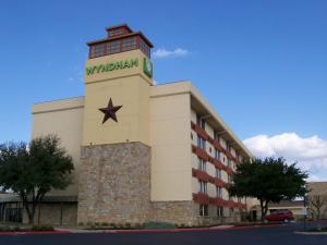 a building with a clock tower on top of it at Wyndham Garden Hotel Austin in Austin