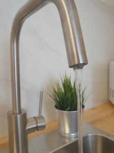 a kitchen sink with water running from a faucet at Morrojable Luxury Beach Apartments in Morro del Jable