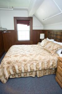 a bedroom with a large bed and a window at Prince of Wales Hotel in Waterton Park