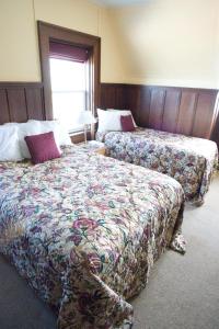 a hotel room with two beds and a window at Prince of Wales Hotel in Waterton Park