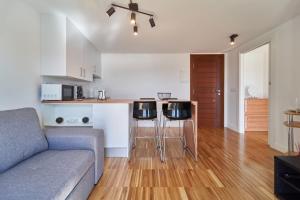 a living room with a couch and a kitchen at Views and Beds in Pontevedra
