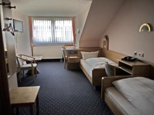 Postel nebo postele na pokoji v ubytování Hotel Ebner