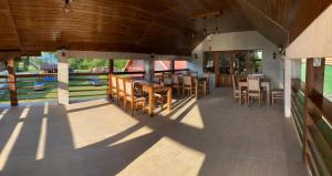 a patio with tables and chairs on a house at Hanul Ursilor in Chişcău