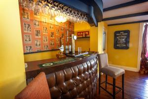 a bar in a restaurant with a counter and chairs at Durham House Holiday Let, sleeps 26 with Croft and Hay Loft in Sedgefield
