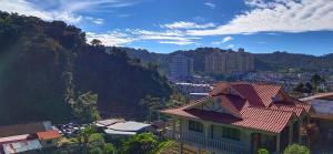 a house with a red roof on a mountain at Muslim homstay@Crown Imperial Court in Cameron Highlands