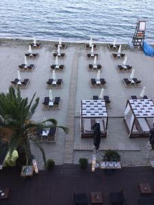 a group of chairs and tables on the beach at Kymata in Paralia Katerinis