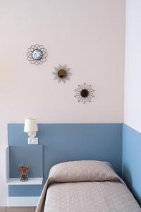 a bedroom with three clocks on the wall at da Fiorella in San Miniato +13 photos