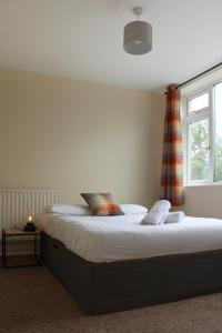 a large bed in a bedroom with a window at Luke stays - Cheveley Park in Durham