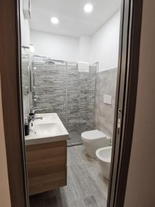 a bathroom with a sink and a toilet at La luce di Ambra in Pagliara +40 photos