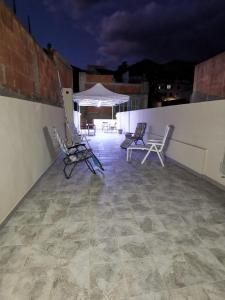 a group of chairs sitting on a roof at night at La luce di Ambra in Pagliara