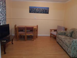 a living room with a table and a couch at AGVA OPAL in Coober Pedy