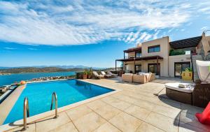 an image of a house with a swimming pool at villa Thalia - Panoramic Sea and Mountains Vew Private pool in Kalidhón