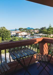 a bench on a balcony with a view of a city at Mami Sabaudia Hotel in Sabaudia