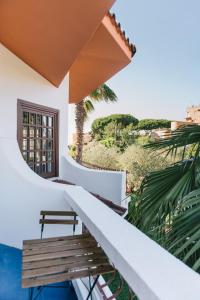a balcony with a bench and a view of the ocean at Mami Sabaudia Hotel in Sabaudia