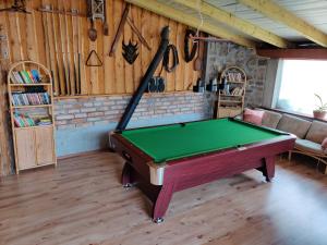 a room with a pool table in a room with a couch at Agroturystyka Szalejów 117 in Szalejów Górny