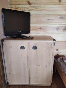einen TV auf einem Holzschrank in der Unterkunft Krainya hata in Melʼniki