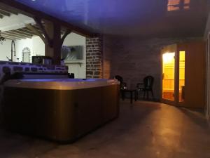 a dark room with a bar and chairs in a building at la caliente in Saint-Mars-sur-la-Futaie