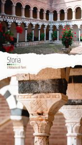 a stone column with flowers on top of a building at Antico Borgo di Torri in Sovicille