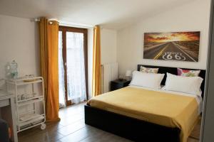a bedroom with a bed and a large window at CENTRALE in Orio al Serio