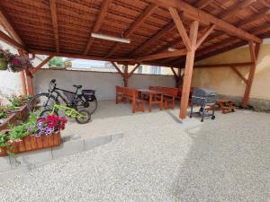 a wooden pavilion with a picnic table and a bike at Apartmány Knížkovi in Slavonice