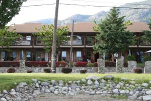 a building with a bunch of rocks in front of it at Lakefront Townhouse Family Complex, Popular Wine Country and the Best Golfing in Osoyoos