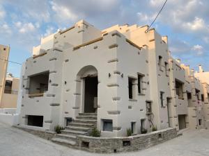 a large building with stairs on the side at Ampelos Casart in Naxos Chora