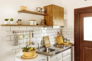 a kitchen with a sink and a bowl of fruit at House Ekton in Pefkari