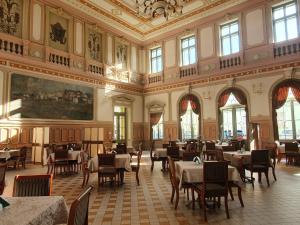 a dining room with tables and chairs in a building at Apartament Mickiewicza - PKP Station in Przemyśl