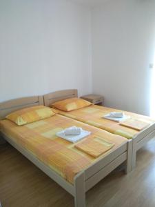a bedroom with a bed with two towels on it at Apartments Vrsalovic in Bol