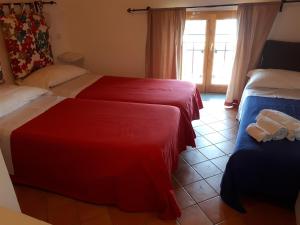 a hotel room with two beds and a window at Casa Falcone B&B in Scala