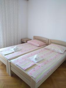 a bedroom with two beds with dishes on them at Apartments Vrsalovic in Bol